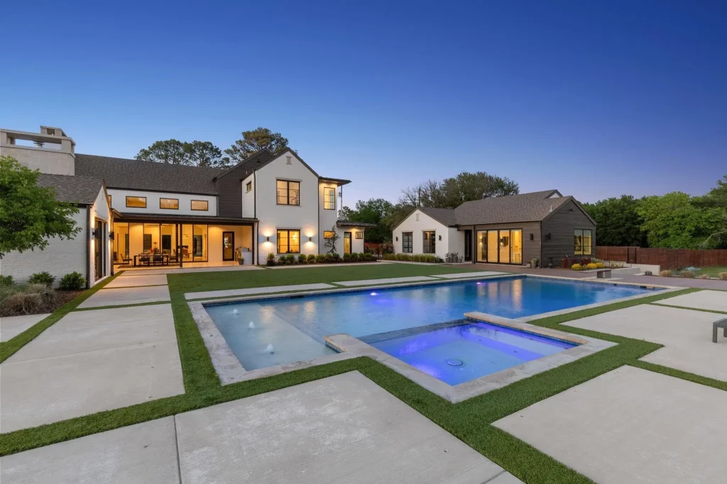 The grounds include turf and a concrete-surrounded pool.