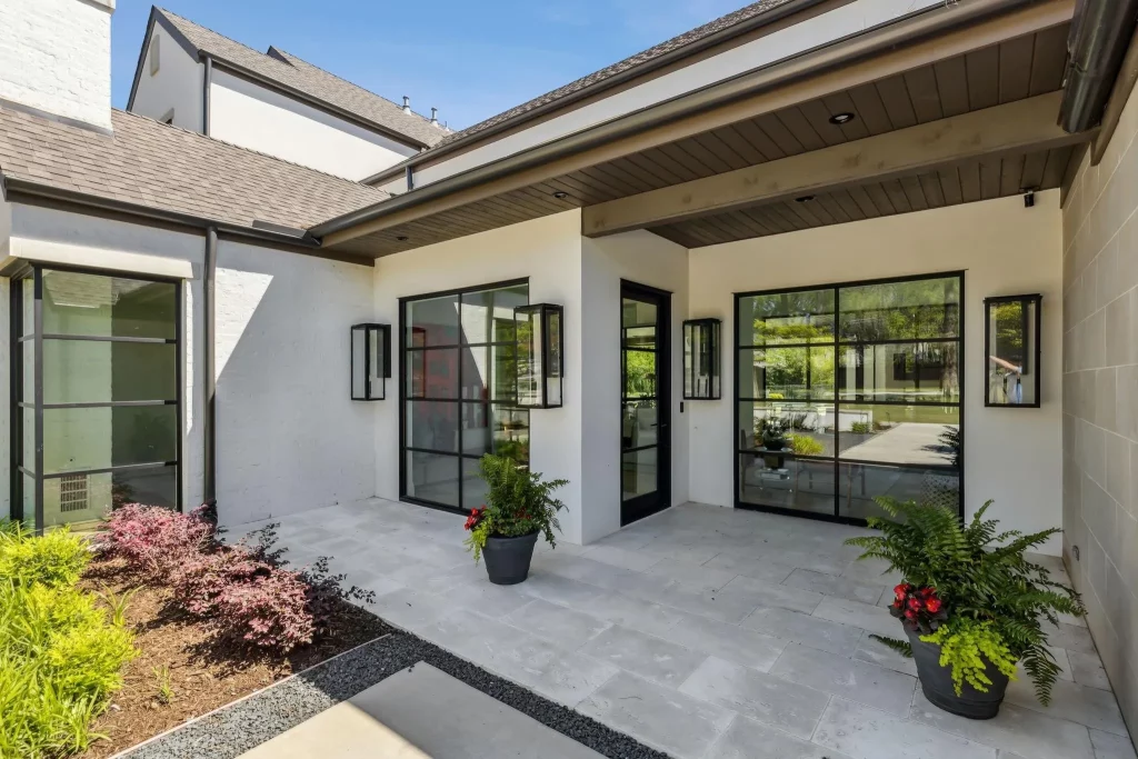 The see-through front entry leads the eye to the lavish backyard.