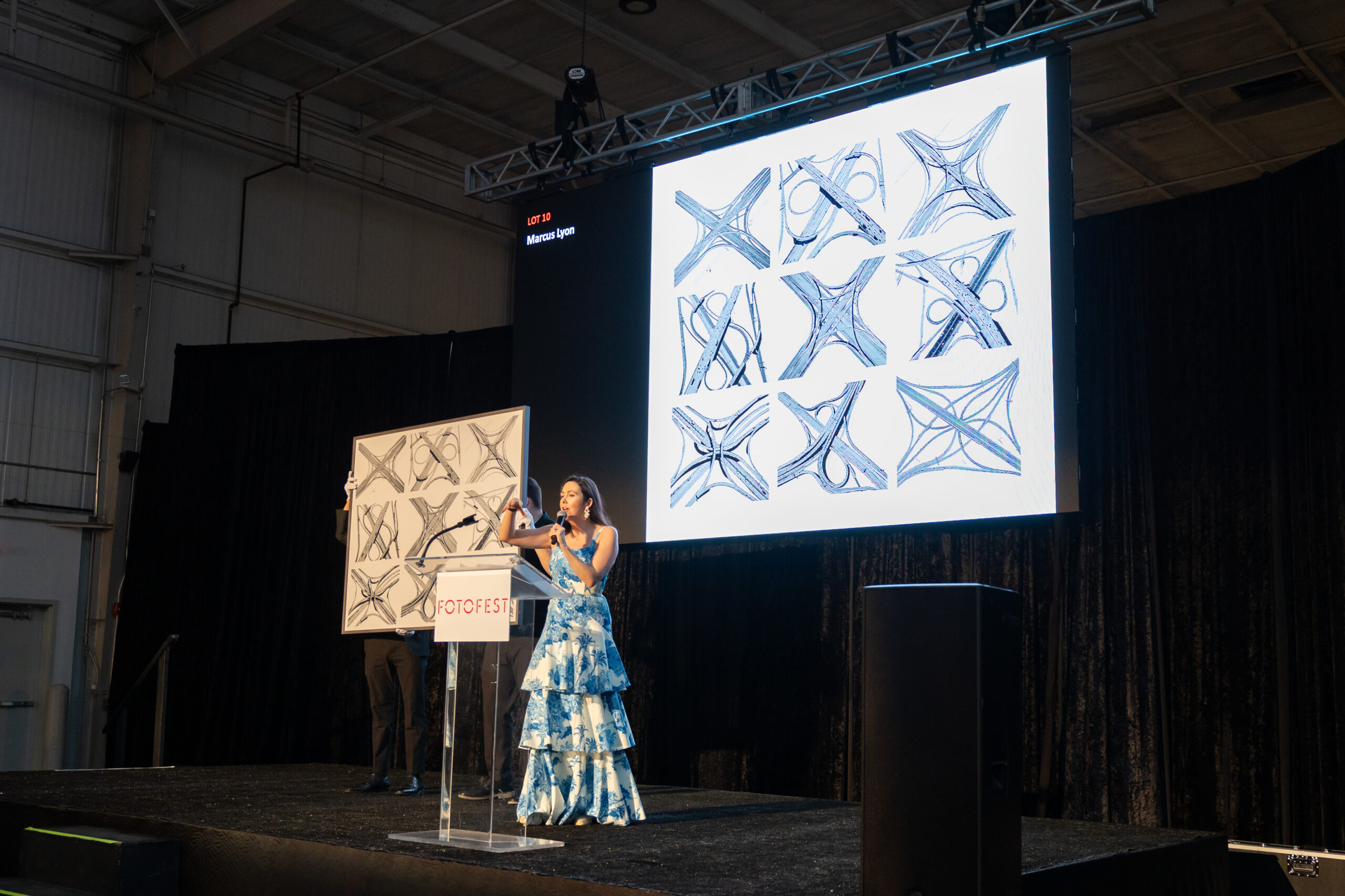 Auctioneer Jacqueline Towers-Perkins with Marcus Lyon's <em>Intersection</em> at FotoFest's 2024 Biennial Fine Print Auction and Gala. (Photo by Melissa Taylor)