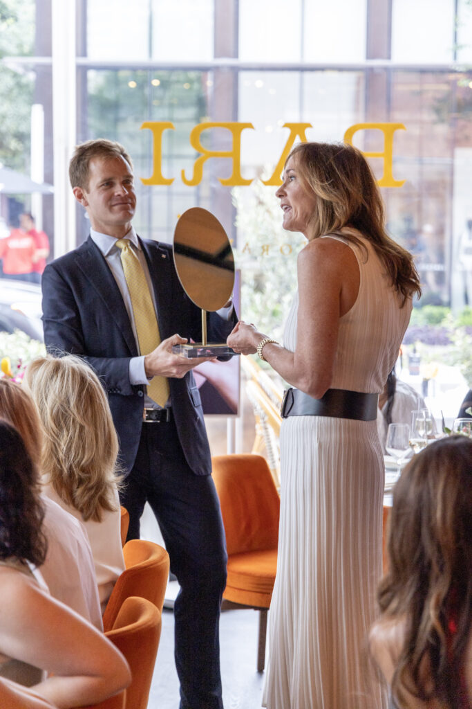 Nick Boulle assists Anna Hernandez in trying on Giorgio B earrings at the de Boulle Diamond & Jewelry lunch at Bari (Photo by Jordan Geibel)