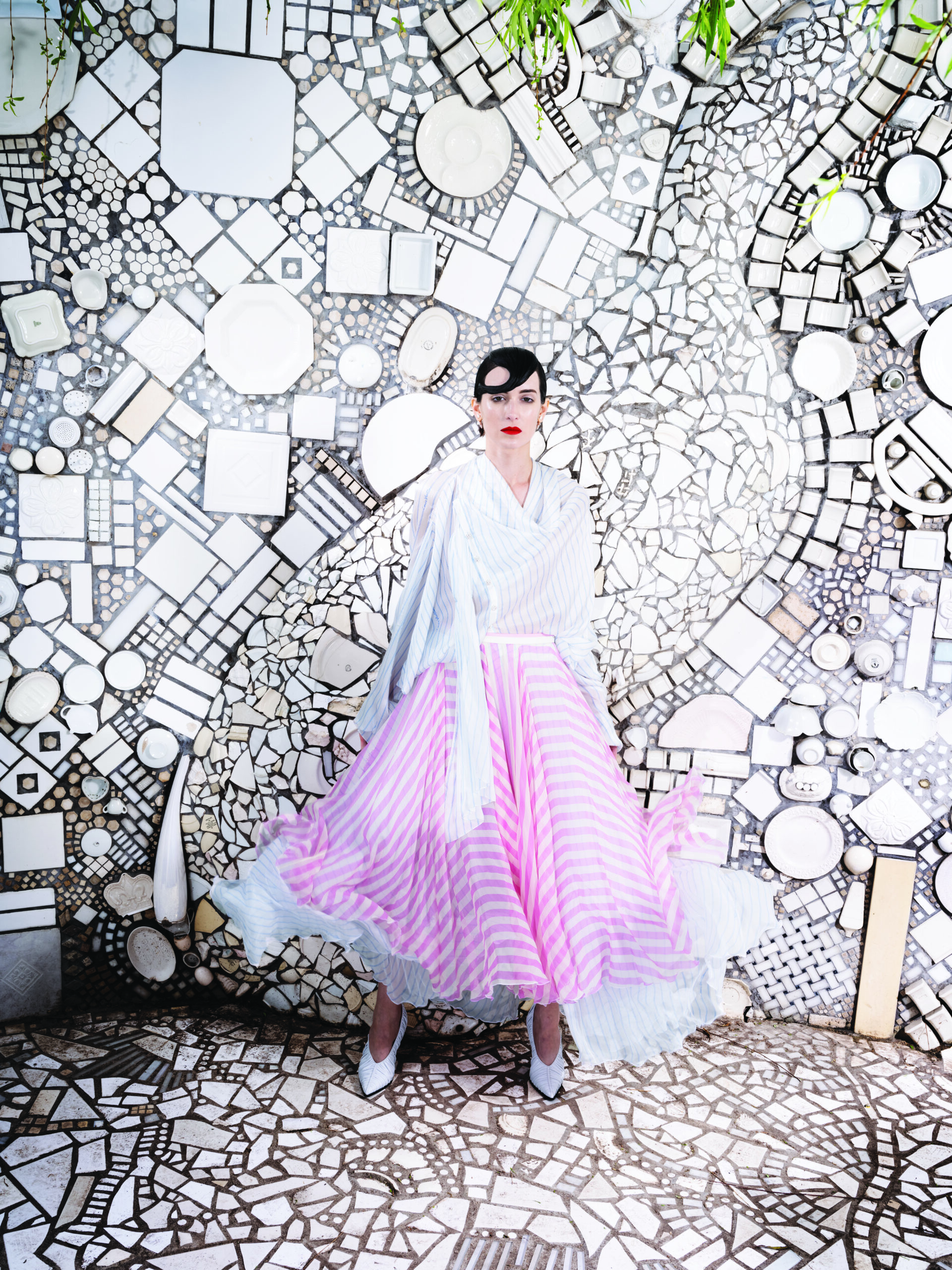 Louis Vuitton double-stripe draped blouse $3,650, mixed-stripe tiered skirt $6,200, and LV Knot pump $1,360.