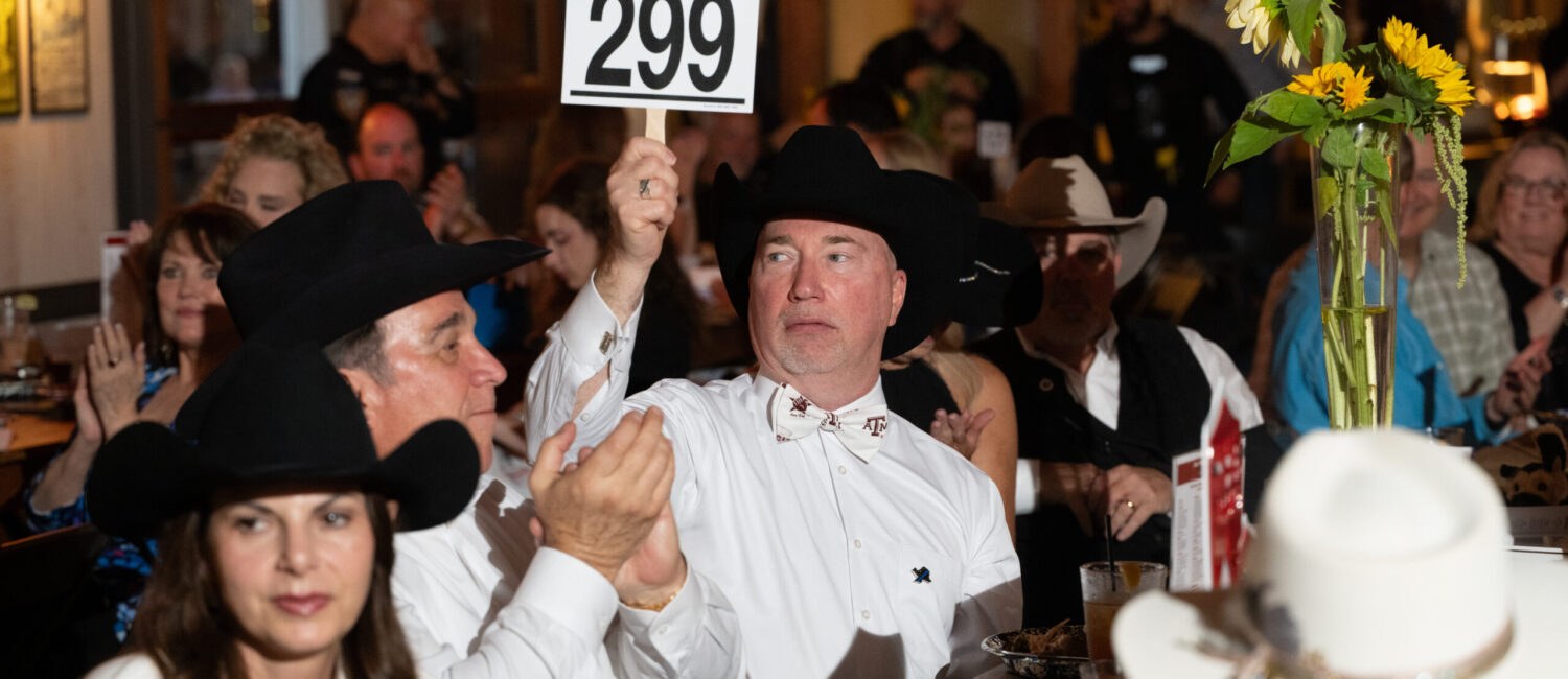 Greg Ploss wins an auction item at the 13th annual K9s4COPS 'Unleashed Gala' (Photo by Daniel Ortiz)