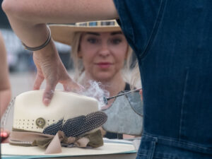 A festival goer customizes a hat purchase at the Big As Texas Music Festival. (Photo by F. Carter Smith)