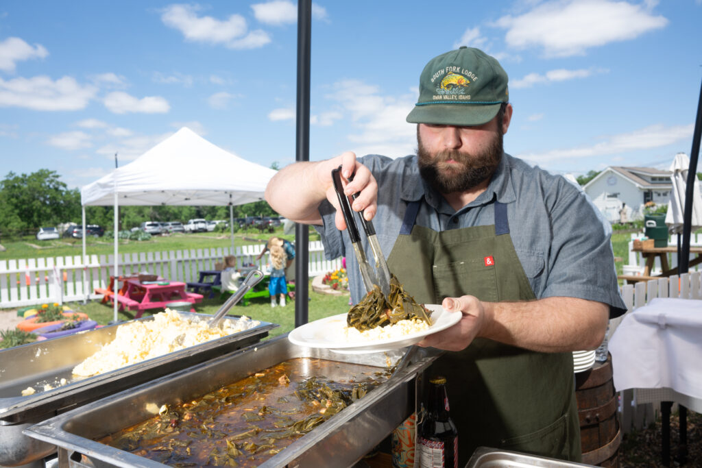 Chef Lucas McKinney of Josephine's serving collard greens  at 'Fashion in the Fields' (Photo by Daniel Ortiz)