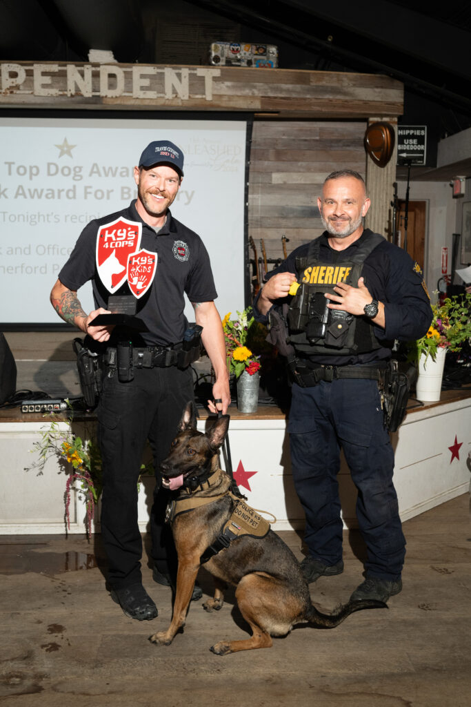 Fire Marshal Ryan Smith, Sgt. Chris Moore, K9 Ember at the 13th annual K9s4COPSs'Unleashed Gala'  (Photo by Daniel Ortiz)