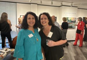 Jenny Carattini-Wright (l) and Annette Palmer at the opening for "A Golden Vision" show at the offices of The Woodlands Arts Council. The exhibit runs through July 11. (Photo by Laura Landsbaum)