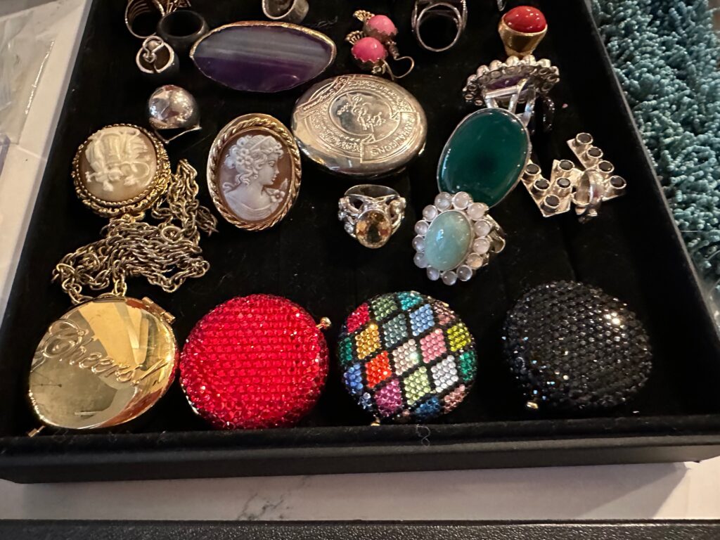 Bejeweled compacts, cameos, and rings are among the items to be sold at 'An Estate of Grace' sale at the Montrose Center. (Photo by Shelby Hodge)