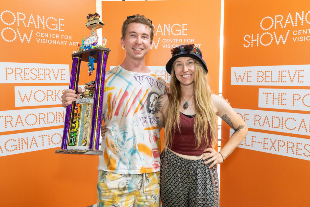 Kyle & Claire Johnson accept Ann Harithas Legacy Award for "The Ploppet" at the Orange Show's Art Car Award Ceremony. (Photo by Emily Jaschke) 
