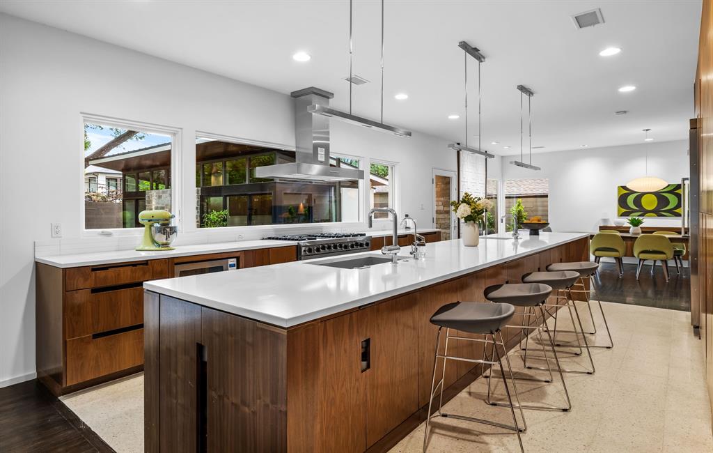 The kitchen features a six-burner range by Viking and a built-in refrigerator. 