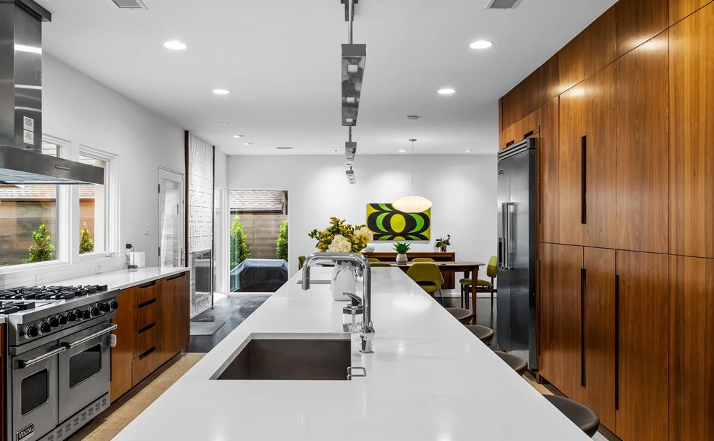 The kitchen features a six-burner range by Viking and a built-in refrigerator. 