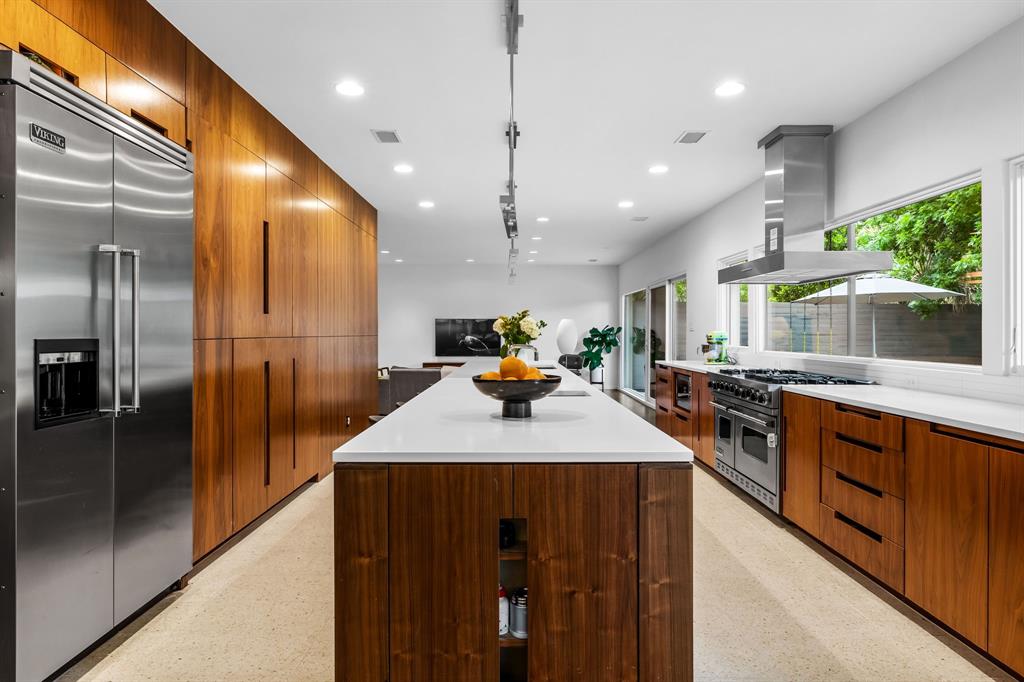 The kitchen features a six-burner range by Viking and a built-in refrigerator. 