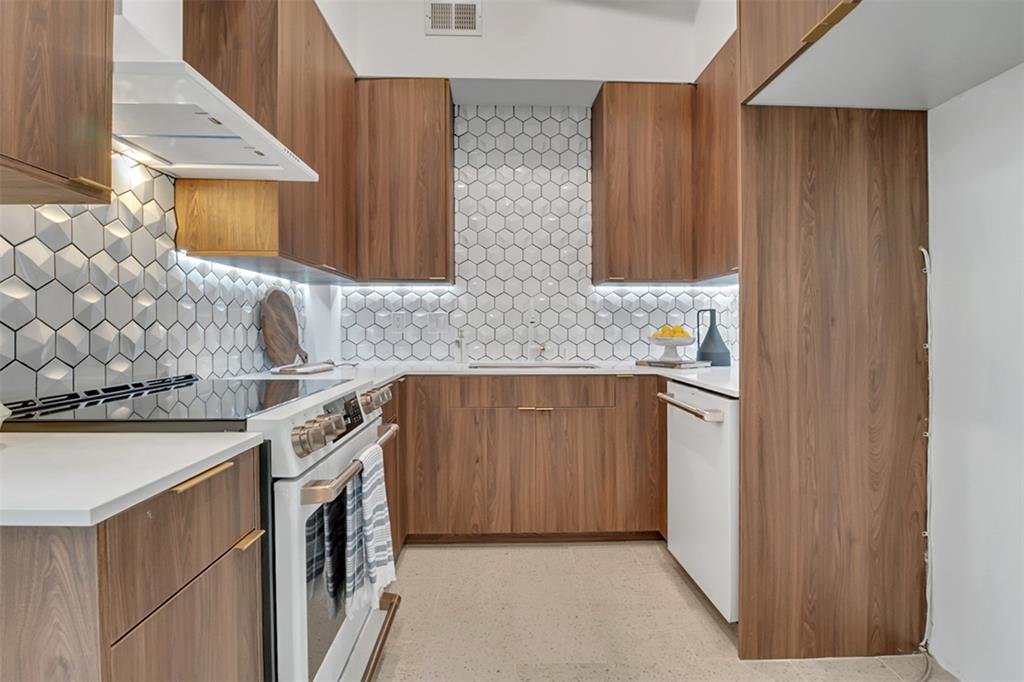 An updated kitchen features appliances from the GE Café series. 