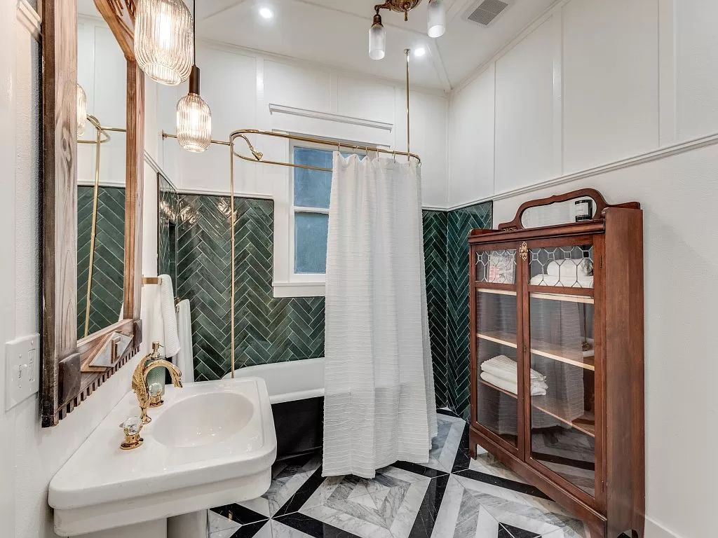 A designer bathroom features a standalone marble tub.