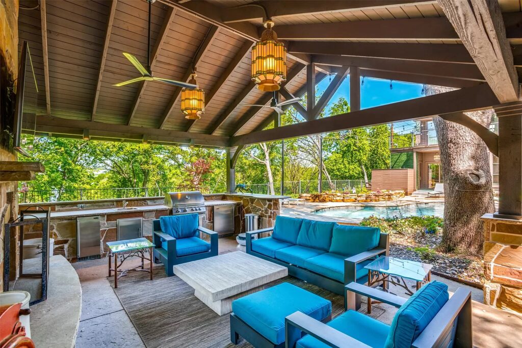 A cabana includes a towering fireplace and outdoor kitchen.