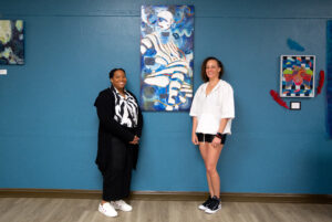 Brittany Ellis and Nicole Durham, both multimedia artists, pose with their collaborative project.