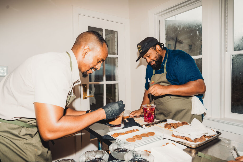 Chefs Khalieb Rufael and Joseph Boudreaux plate Injera Crisp, Whipped Shiro, and Fresh Pepper at the Juneteenth Jubilee dinner.