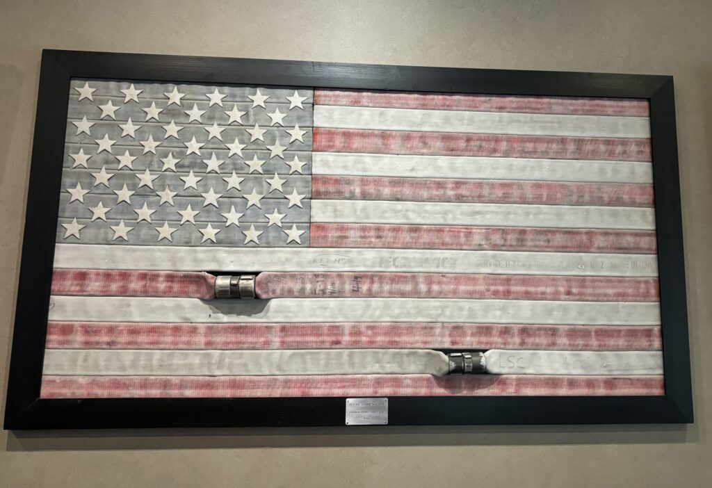 A flag made of fire hoses hangs in the Republic Grill. It is dedicated to Deputy Fire Chief Walker. (Photo by Laura Landsbaum)