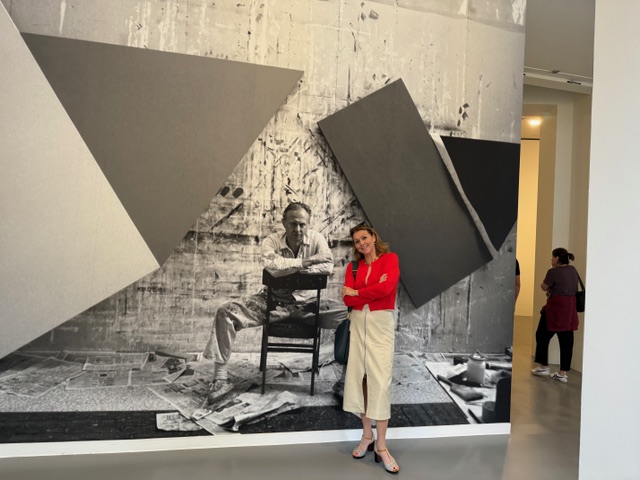 Donatella poses with a portrait of Ellsworth Kelly