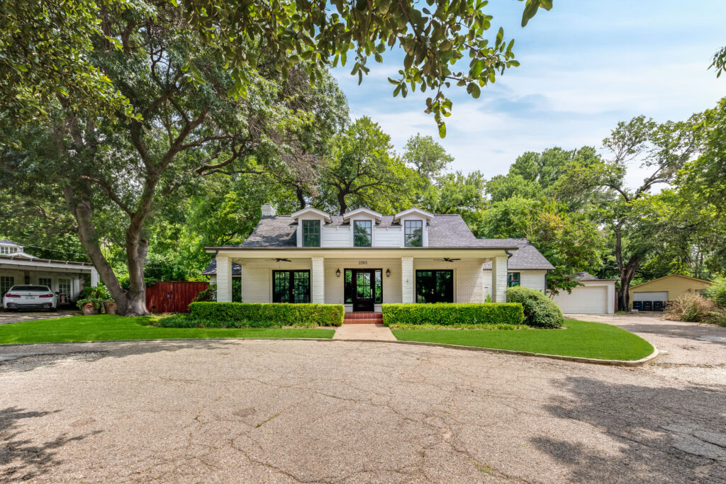 At 2365 Park Place, three symmetrical dormers rise above the covered front porch.