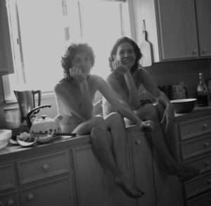 Mary Margaret Hansen’s “After Breakfast Photo Shoot,” circa 1980s, is a feminist take on the concept of being a housewife. The image is a portrait of the photographer (left) with fellow photographer/collaborator Patsy Cravens. 