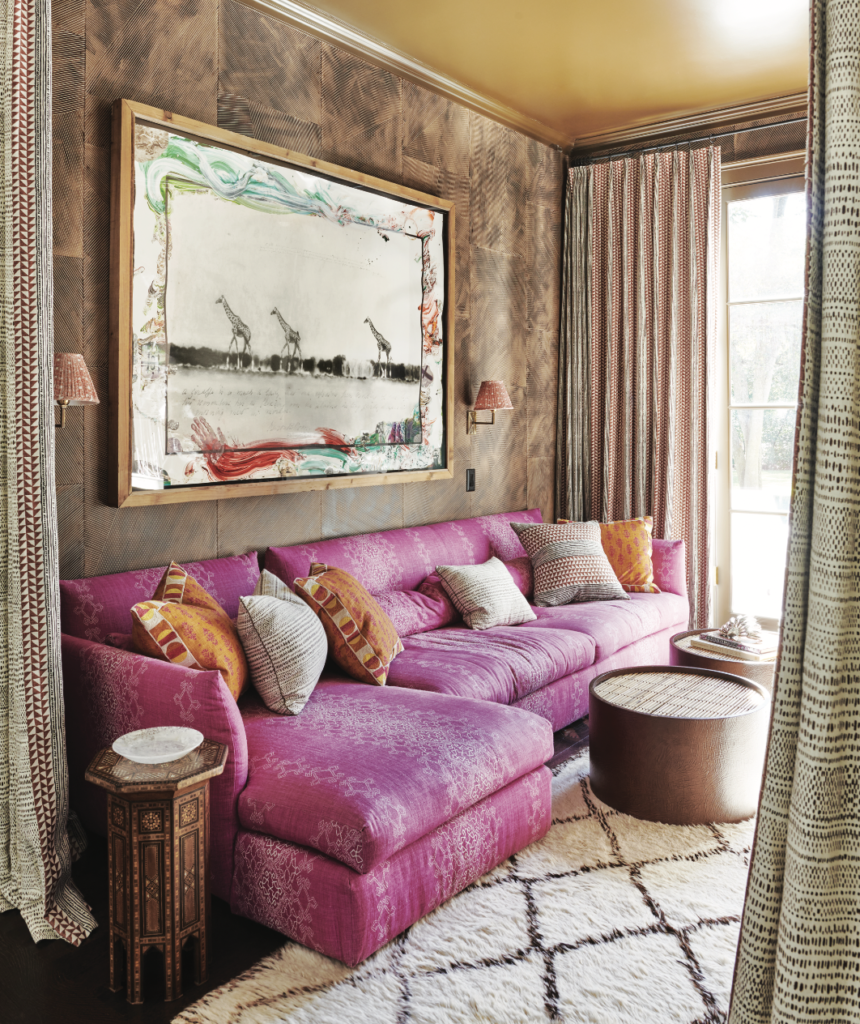 The snuggery’s wallpaper, drapery, and sofa upholstery and pillow fabrics are all from James. Drum tables from Scott + Cooner. Peter Beard artwork. Vintage Moroccan rug.  (Photo by Richard Powers)
