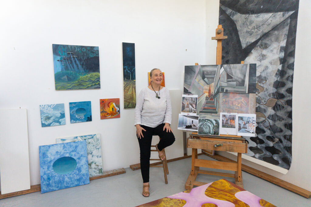 Arielle Masson surrounded by her paintings (Photo by Sofia Westerman) 