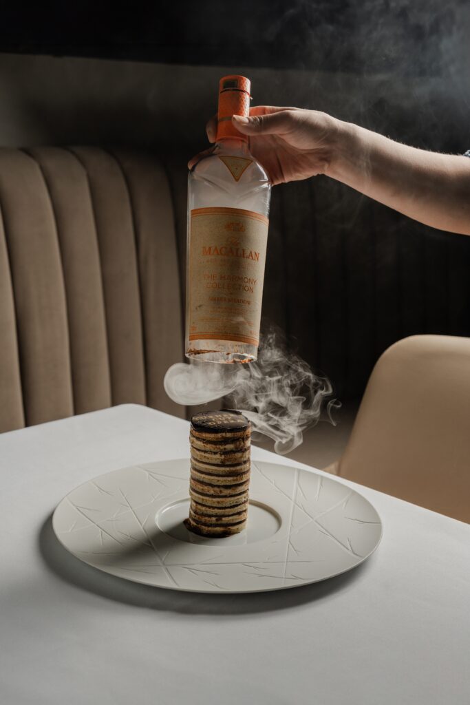 he meal ends with a sartorial splash, especially if you order corporate pastry chef Ruchit Harneja’s showstopping Turner's Cut Opera, a classic French layered cake composed in a cylindrical fashion, brought to the table beneath a cloche of a different sort: a Macallan bottle that emits a coffee-scented smoke as it's lifted to reveal the pastry inside ($19). (Photo by Brian Kennedy)