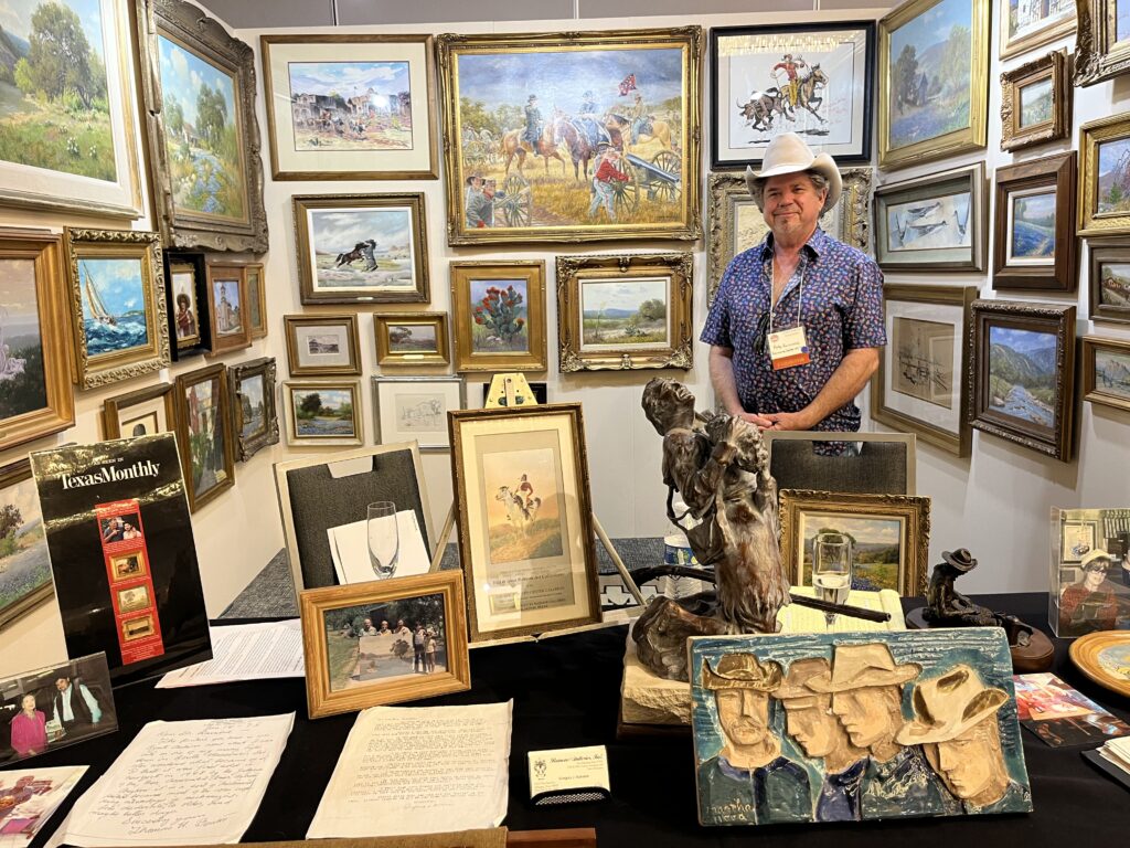 Pete Rainone of Rainone Galleries Inc. rocks a cowboy hat standing amidst his gallery's selection of early Texas art. (Photo by Jenna Baer)