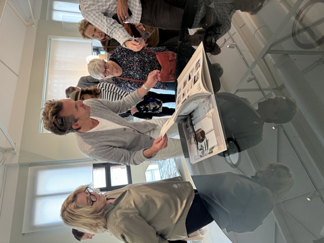 Mathieu Lehanneur shows visitors a lookbook of his designs at The Factory. (Photo by Donatella Benckenstein)