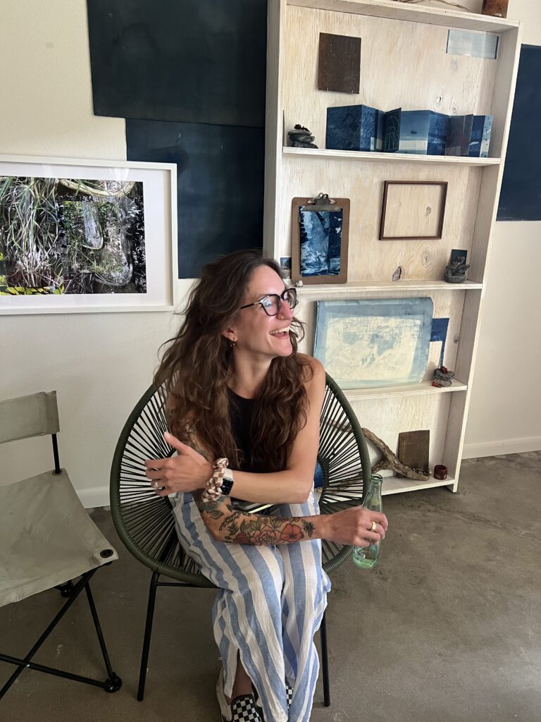 Adrienne Simmons sits amongst her works at FLATS' "Interwoven." (Photo by Catherine D. Anspon)