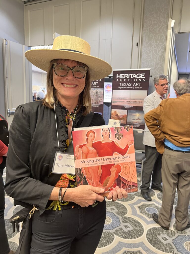 Tanja Peterson shows off her new copy of "Making the Unknown Known." (Photo by Catherine D. Anspon)