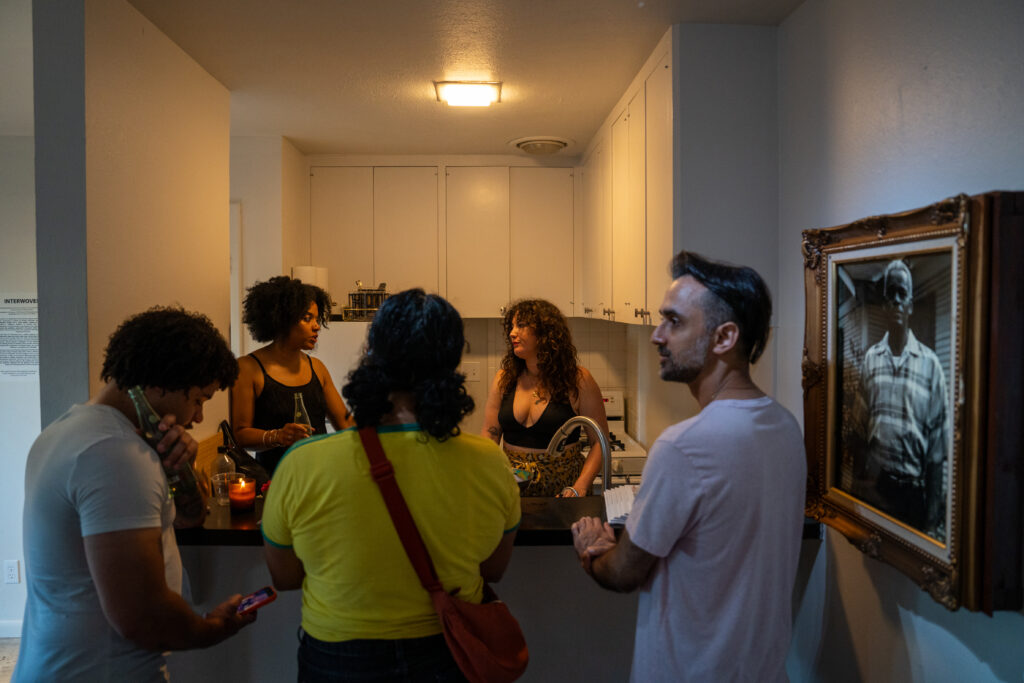 FLATS' founders Ryan Francisco and Jessi Bowman discuss the exhibition with friends at FLATS' "Interwoven." (photo by Alan Nguyen)