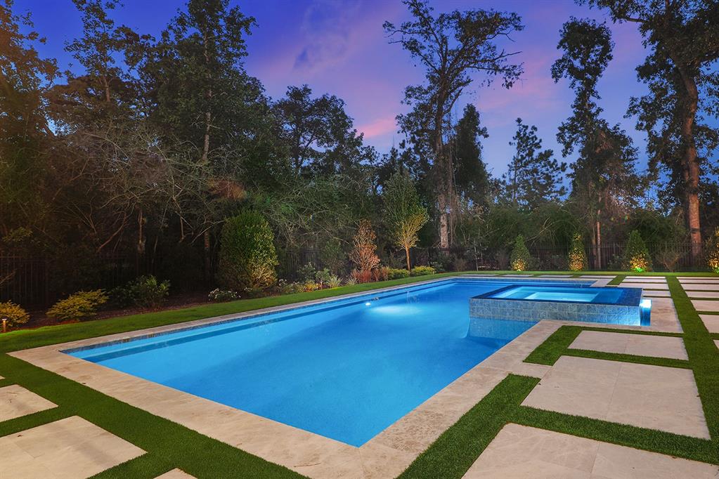 The sleek swimming pool blends seamlessly into the backyard making for the perfect place to relax. 