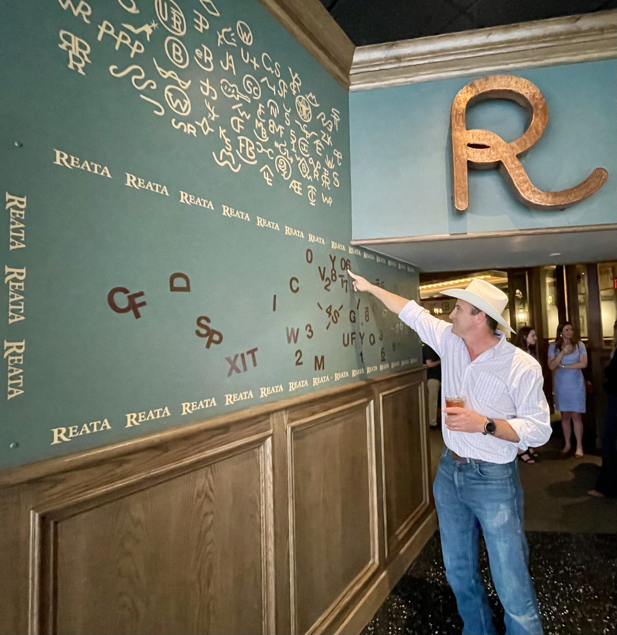 Mike Micallef points to the brand wall