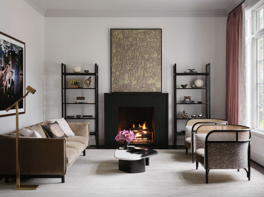 In the living room, a pair of mahogany bookcases from CB2. Holly Hunt coffee table, Targa lounge chairs from Artemest in Zak+Fox fabric and Edelman leather. Harry Bouras painting from Sputnik Modern.  (Photo by Lisa Petrole)