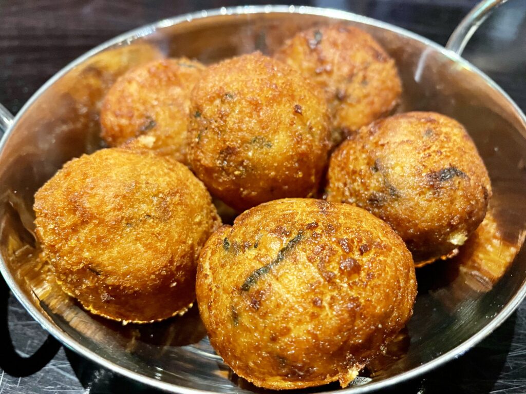 Crispy fried balls of Spanish serrano ham croquettes are doughy at the center. (Photo by Courtney Dabney)