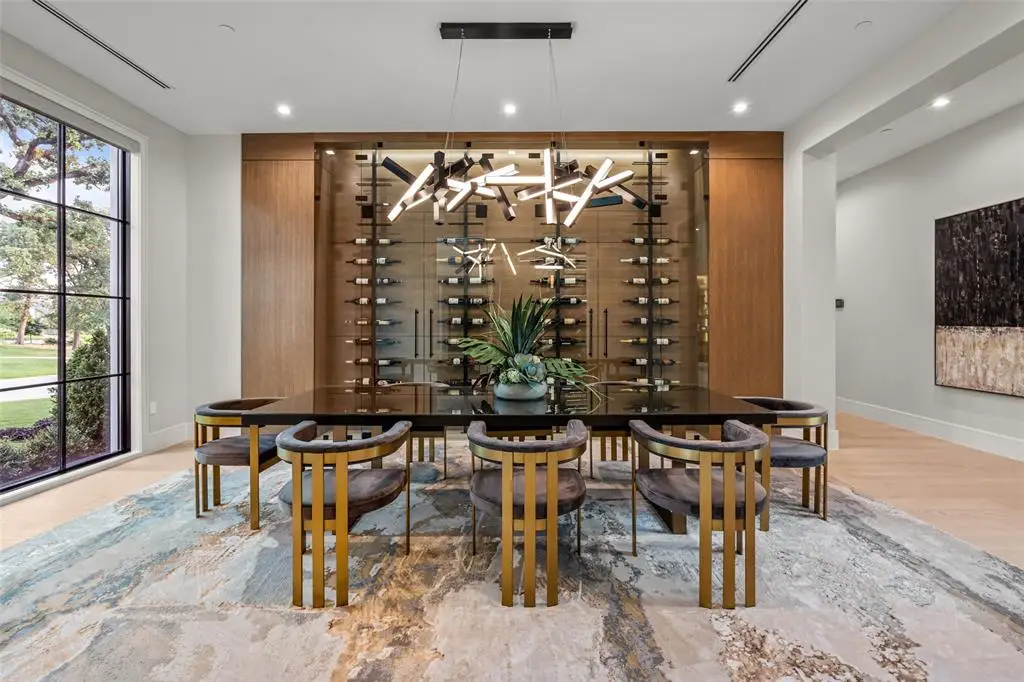 The modern dining room with a custom wine wall at 1609 Meandering Way Drive.