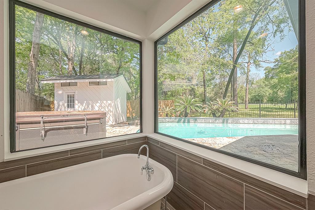 With sleek modern bathrooms throughout the property, enjoy views of the backyard from the tub.