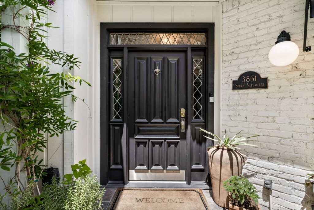 The leaded beveled diamond front door was painted an inky black. 