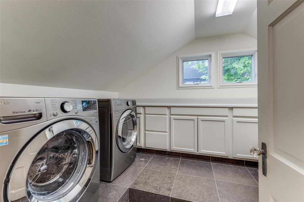 An airy laundry room comes with plenty of storage.  (Photo by Micalizzi Real Estate)