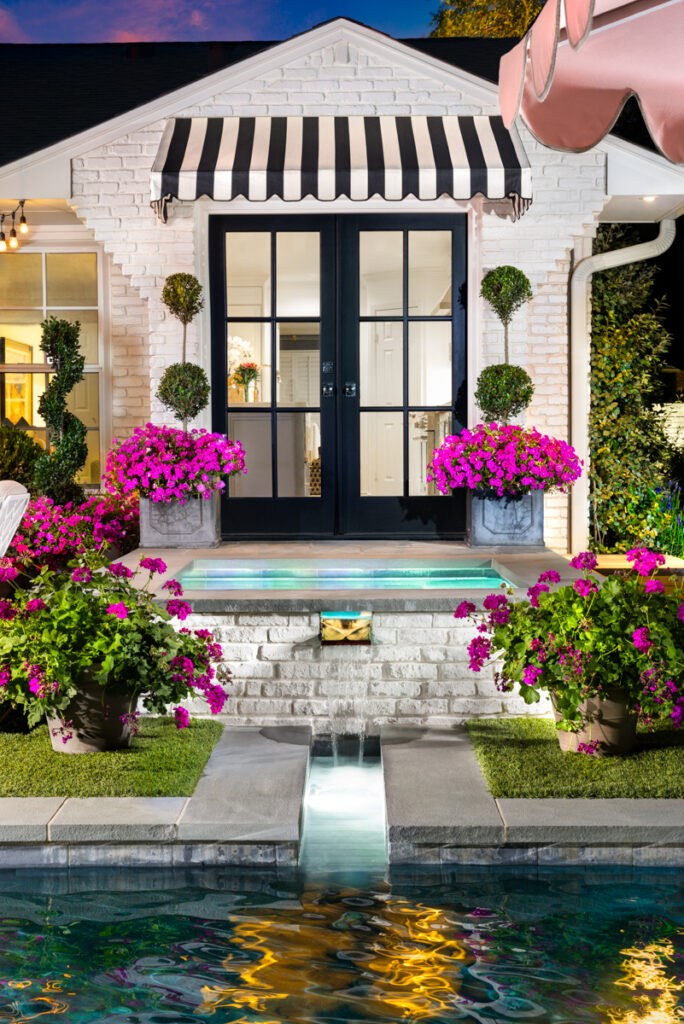 Lush plants and pops of pink accent the Palm Springs-inspired patio and pool. (Photo by Jennifer Baker)