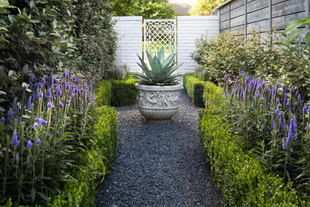 The vintage white iron gate was salvaged from a Highland Park residence. (Photo by Jennifer Baker)