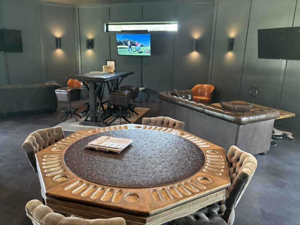 Addison Woods' groom's cabin has pool, a card table, showers, and television screens.  Just steps away are the pond and putting green. (Photo by Laura Landsbaum)