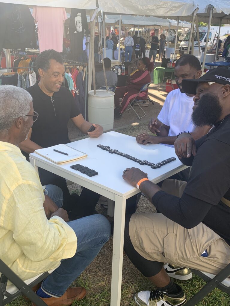 Floyd Newsum playing dominoes with Rick Lowe and Jesse Lott's son, Wayne Myles, during a 30th Anniversary celebration held during the "Founders Round" at Project Row Houses. (Photo by Ericka Schiche)