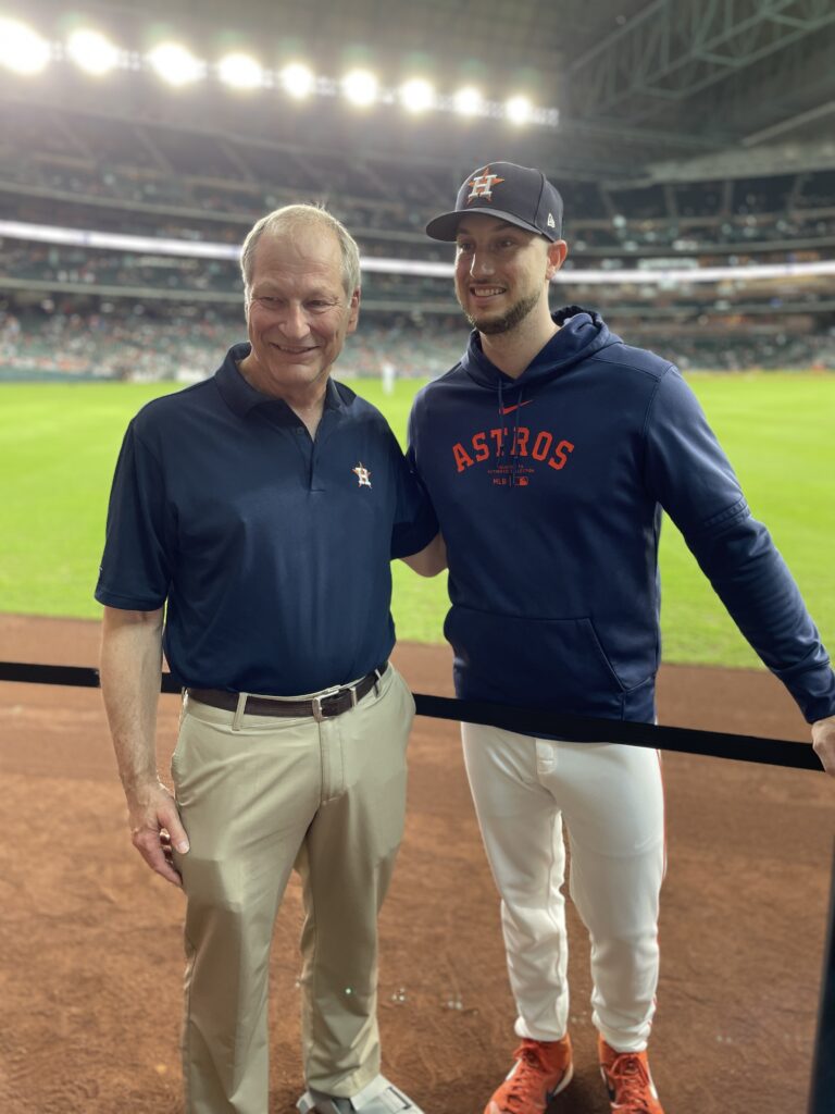 Dr. Paul Mansfield and Astros star Kyle Tucker share a moment on the field. (Photo by Kim Antley)