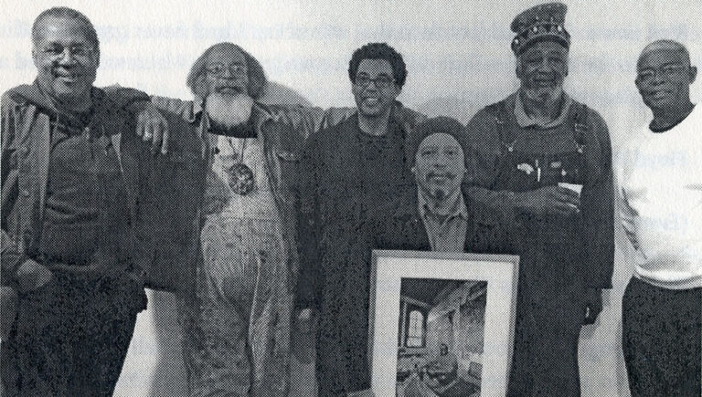 Floyd Newsum with other co-founders of Project Row Houses. From left: Project Row Houses co-founders George Smith, Bert Long Jr., Rick Lowe, Bert Samples (holding a framed photo of the late James Bettison), Jesse Lott and Floyd Newsum. (Courtesy Project Row Houses)
