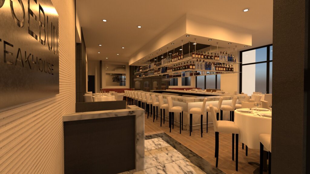 The island-shaped bar is located to the right of the entrance at Rosebud Steakhouse.