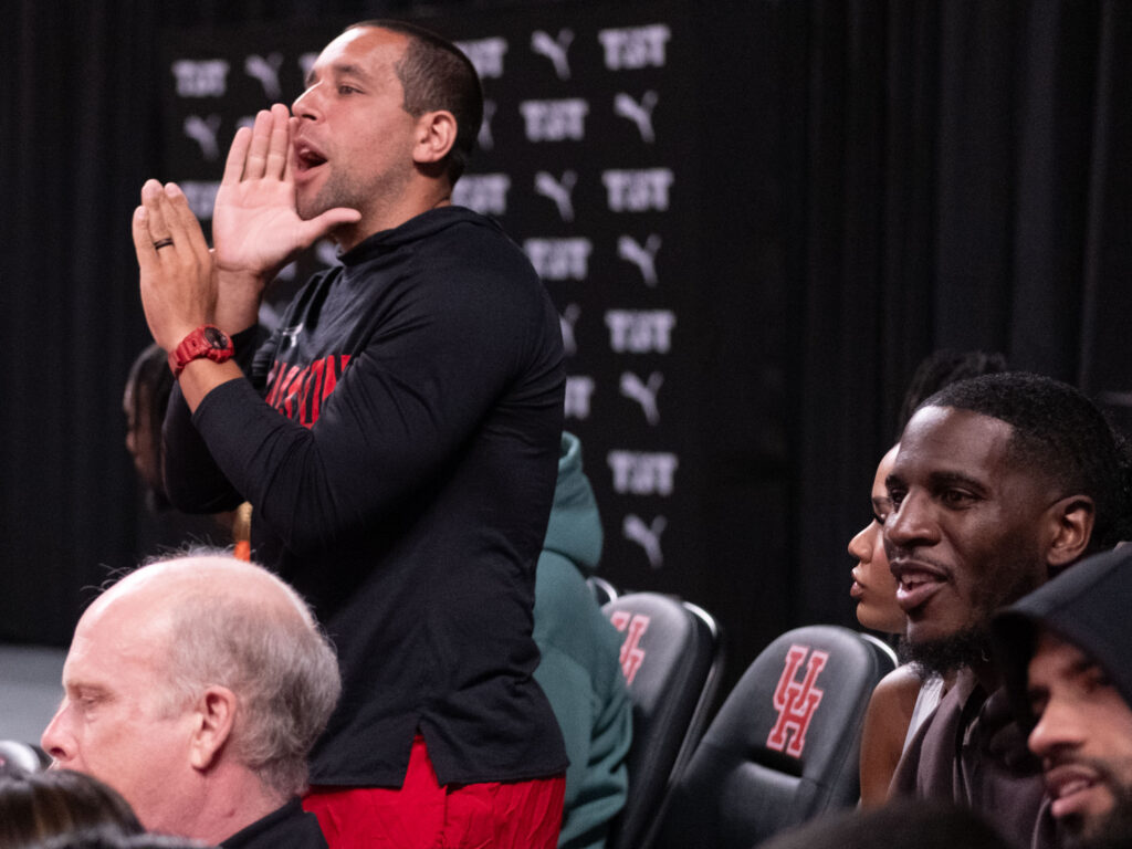 University of Houston assistant coach Kellen Sampson loves cheering on the program's former players. (Photo by F. Carter Smith)