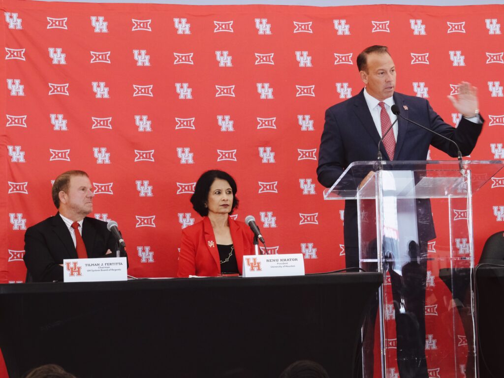 Tilman Fertitta makes a point as new University of Houston athletic director Eddie Nunez and president Renu Khator look on. (Photo by F. Carter Smith)