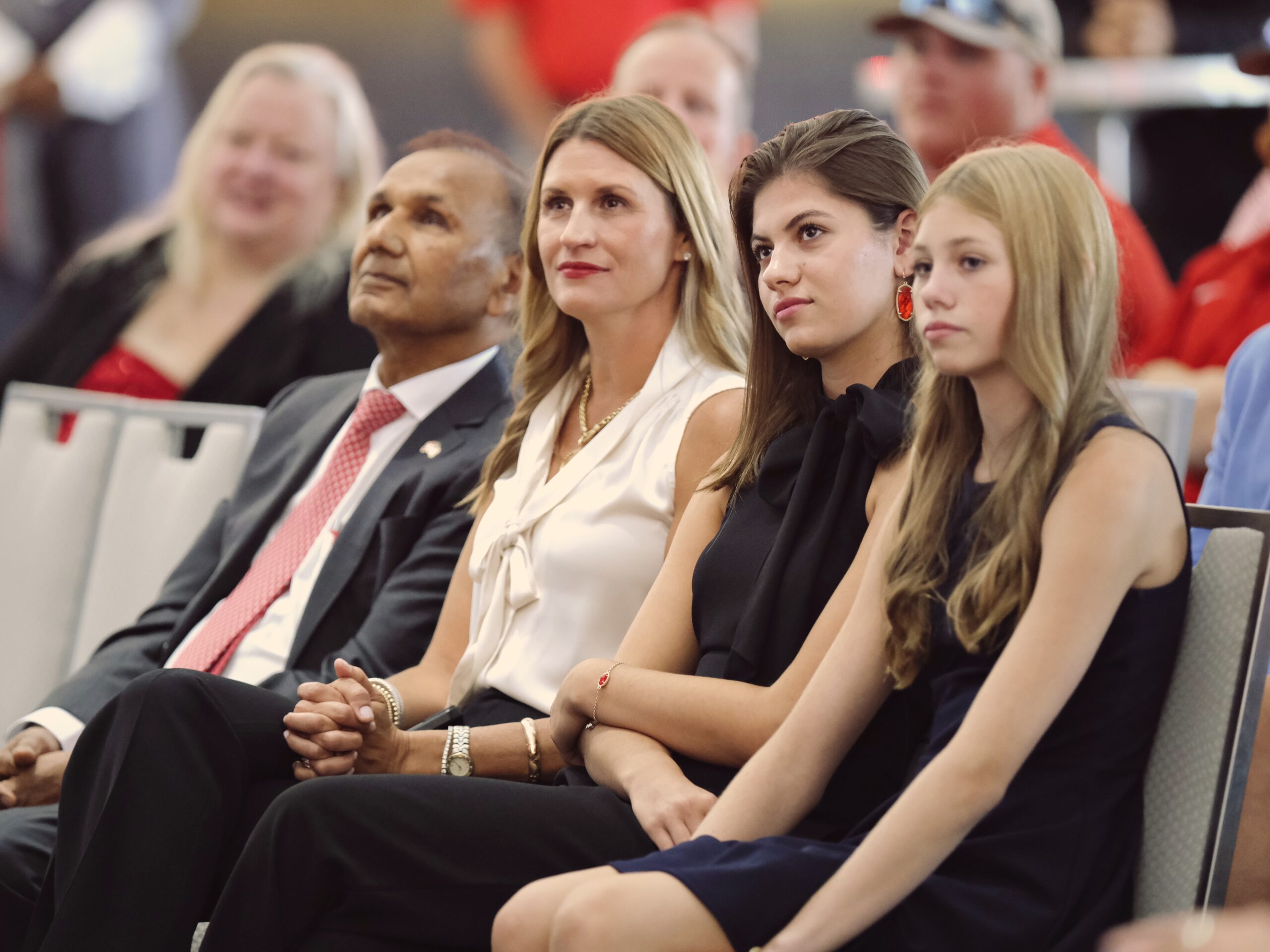 Renu Khator’s husband Suresh Khator, the associate dean of engineering, Jane Nunez, Elizabeth Nunez and Ann Nunez watch Eddie Nunez make his first appearance at UH’s new athletic director. Eddie Nunez leans on his wife and daughters for support. (Photo by F. Carter Smith)